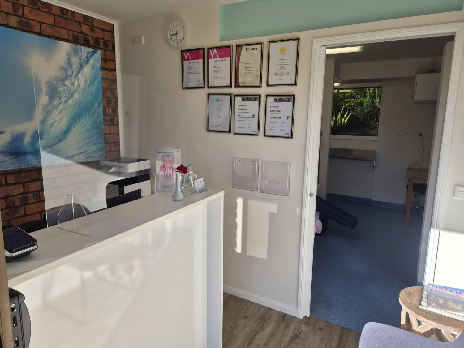 Inside CAV Denture Clinic in Bilambil Heights — reception, treatment room and the prosthetist’s qualifications on the wall