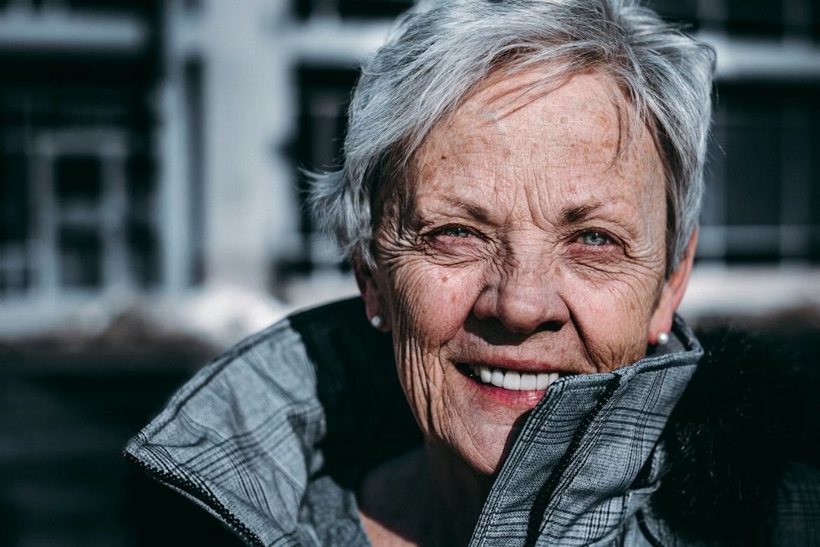 A happy patient smiling with confidence after denture treatment