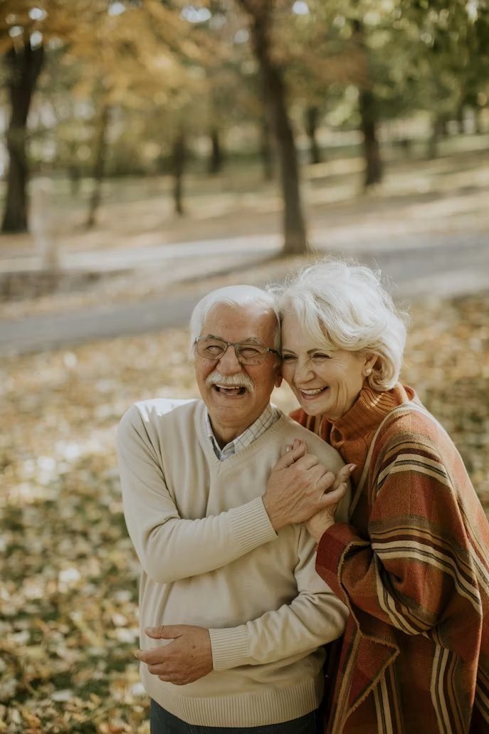 A happy older couple at home, supported by CAV Denture Clinic's mobile service