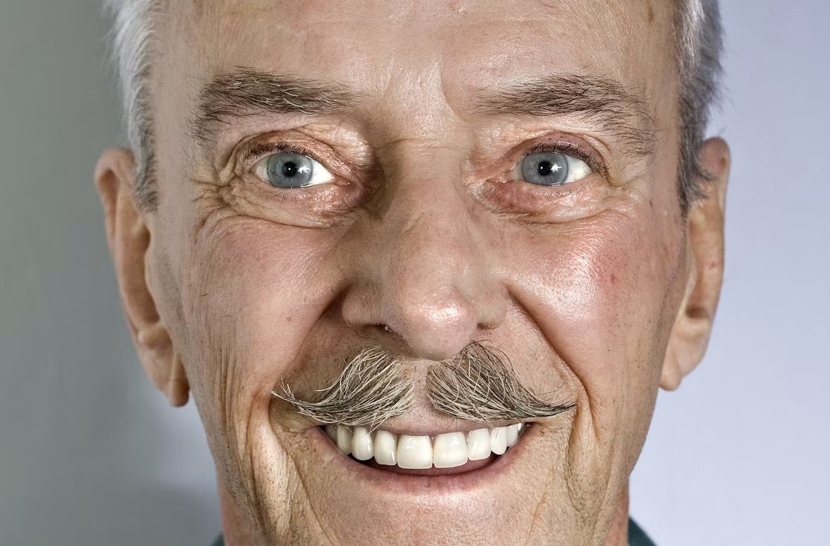 An older gentleman smiling with confidence